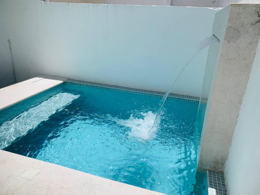 a swimming pool with a water fountain at Casa Boca in Boca del Río