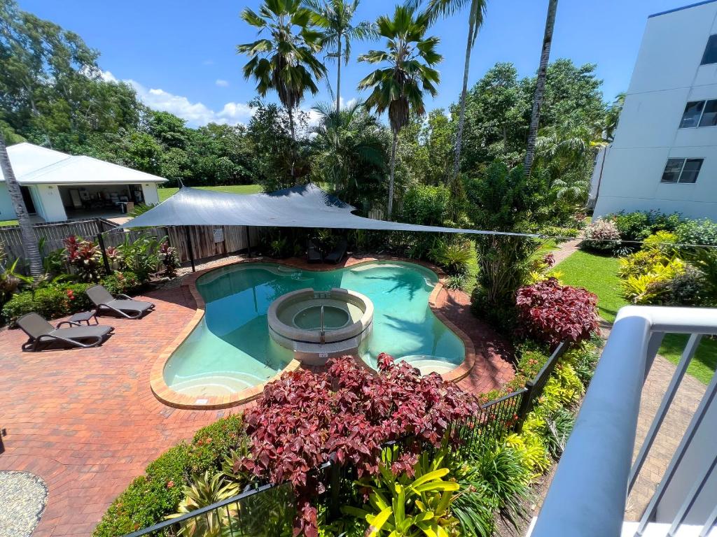 a swimming pool in the middle of a yard at 6 Ulysses - Spacious Beachfront Apartment in Mission Beach