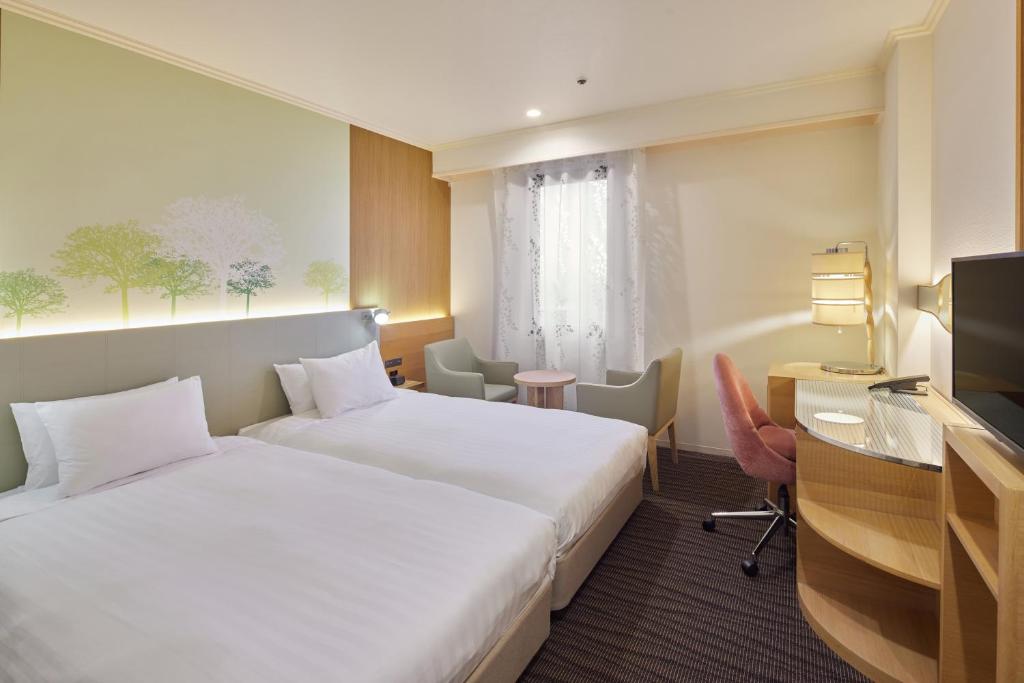 Postel nebo postele na pokoji v ubytování Kichijoji Excel Hotel Tokyu