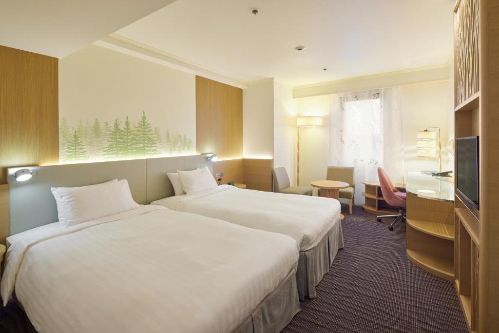 Postel nebo postele na pokoji v ubytování Kichijoji Excel Hotel Tokyu