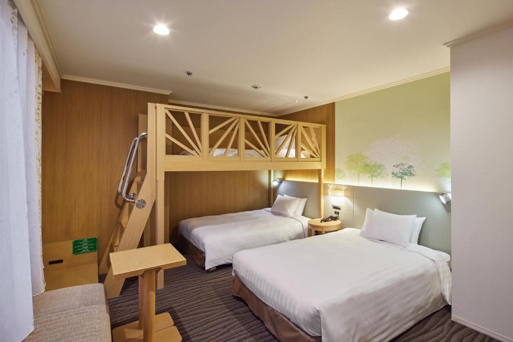 Postel nebo postele na pokoji v ubytování Kichijoji Excel Hotel Tokyu