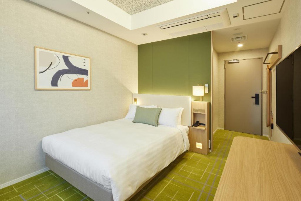 Postel nebo postele na pokoji v ubytování Kichijoji Excel Hotel Tokyu