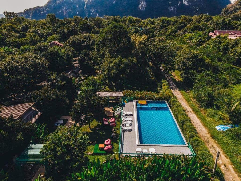an overhead view of a swimming pool with a mountain at The Royal Bamboo Lodges - SHA Certified in Khao Sok