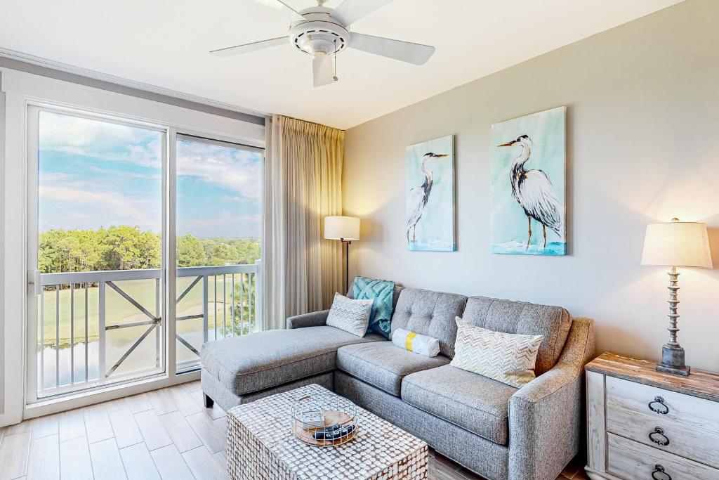 a living room with a couch and a balcony at Elation #5416 - Baytowne Breeze in Destin