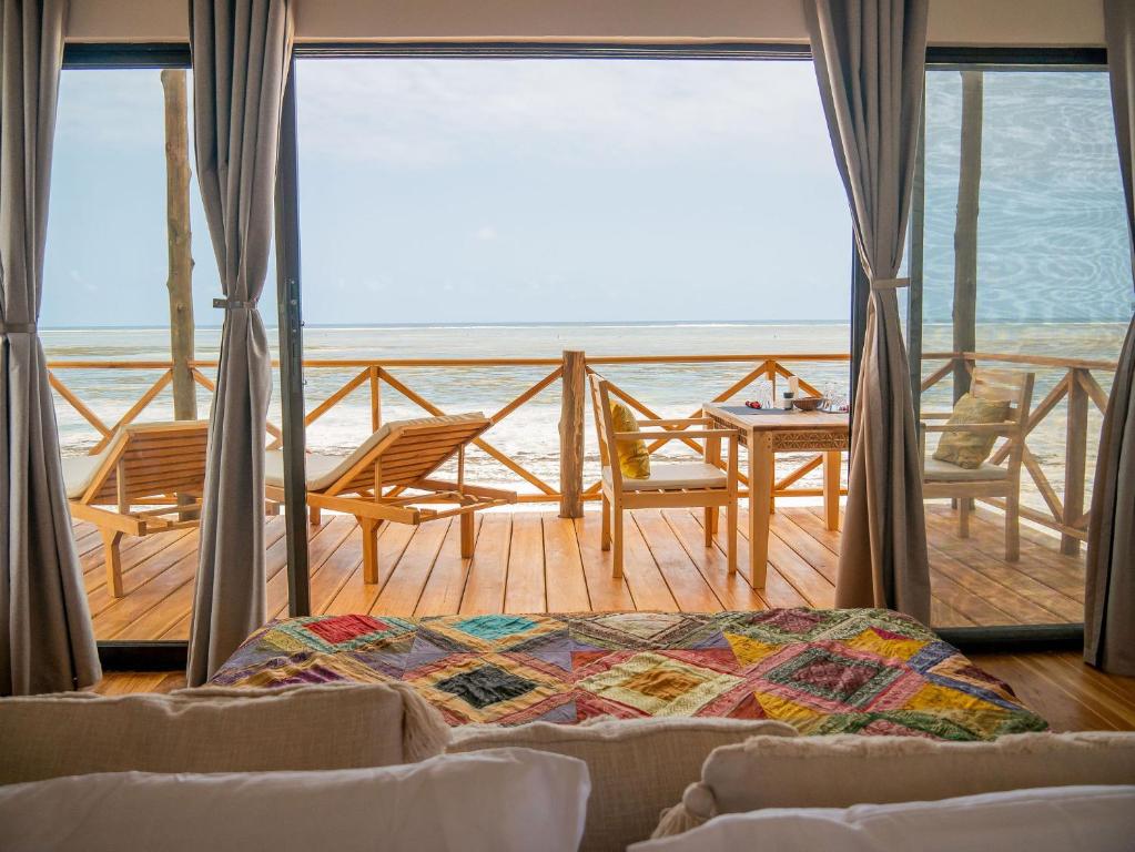 a living room with a view of the ocean at CoCo Tree House @ Kima Zanzibar, Unique stay in Bwejuu