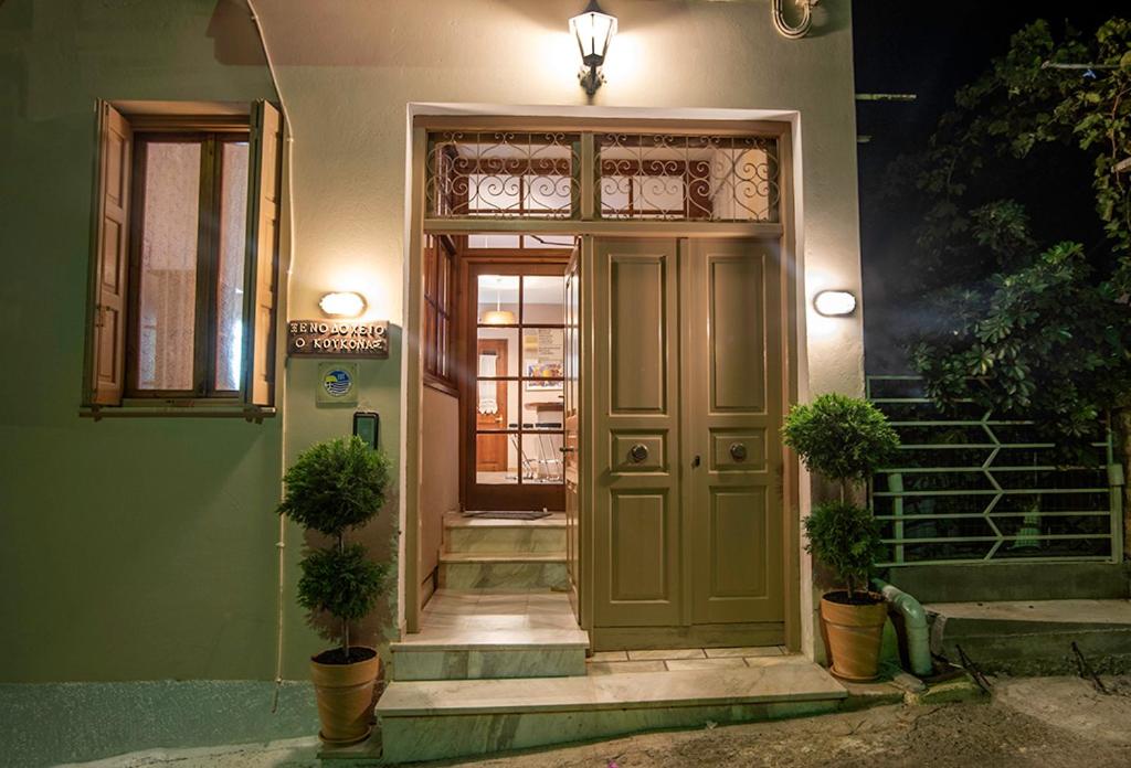 a front door of a house with potted plants at Koukonas in Galaxidi