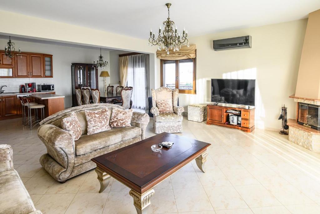 a living room with a couch and a coffee table at 4 Seasons Home in Alexandroupoli