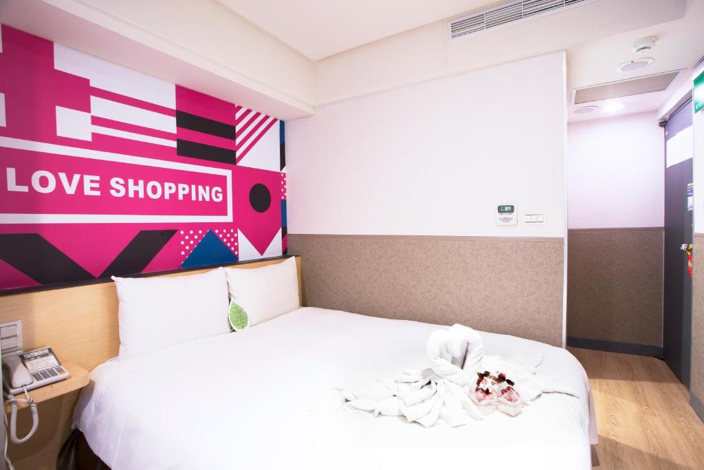 Postel nebo postele na pokoji v ubytování Ximen Citizen Hotel