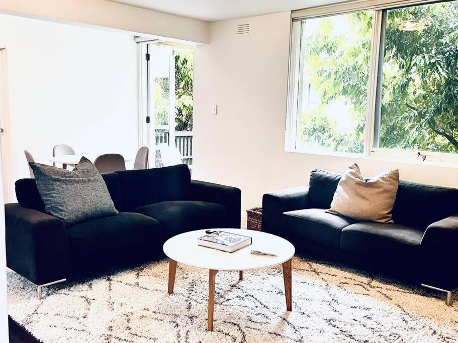a living room with two couches and a coffee table at Two bedroom South Melbourne Apartment on Montague in Melbourne