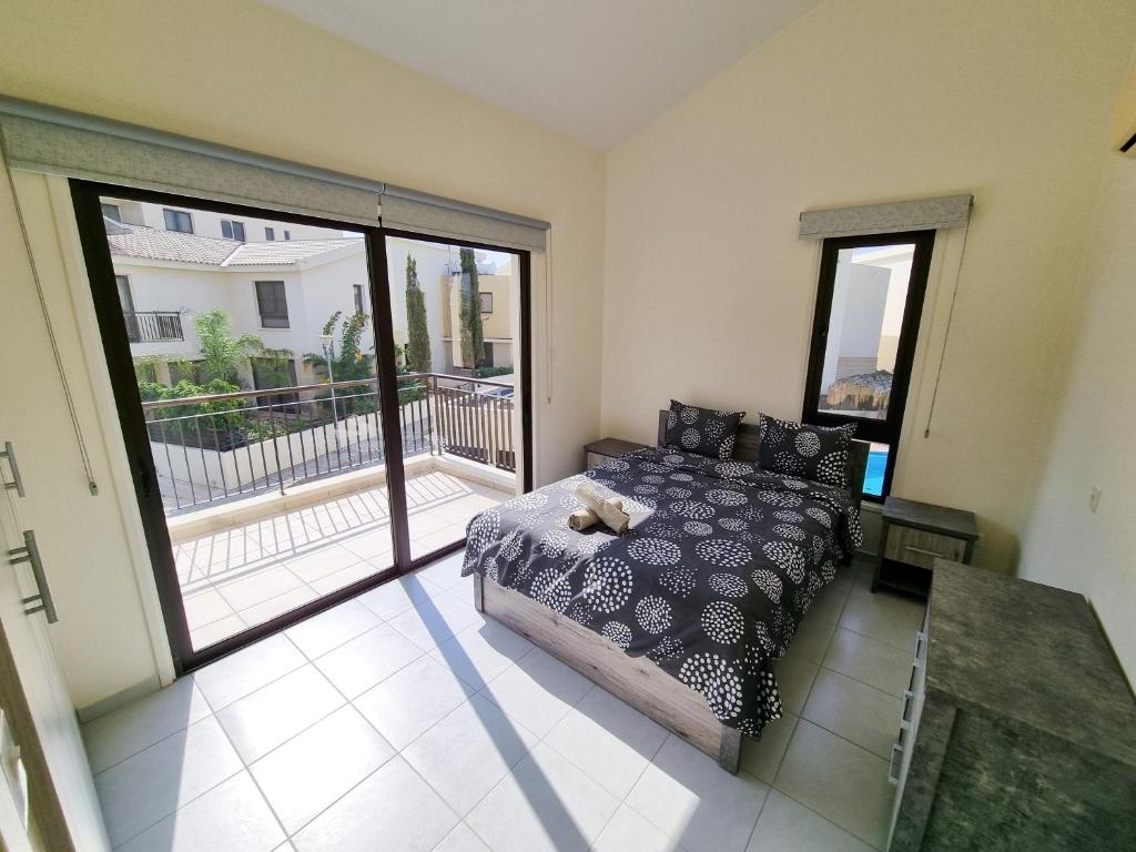 a bedroom with a bed and a large sliding glass door at Liza Dream House in Tersephanou