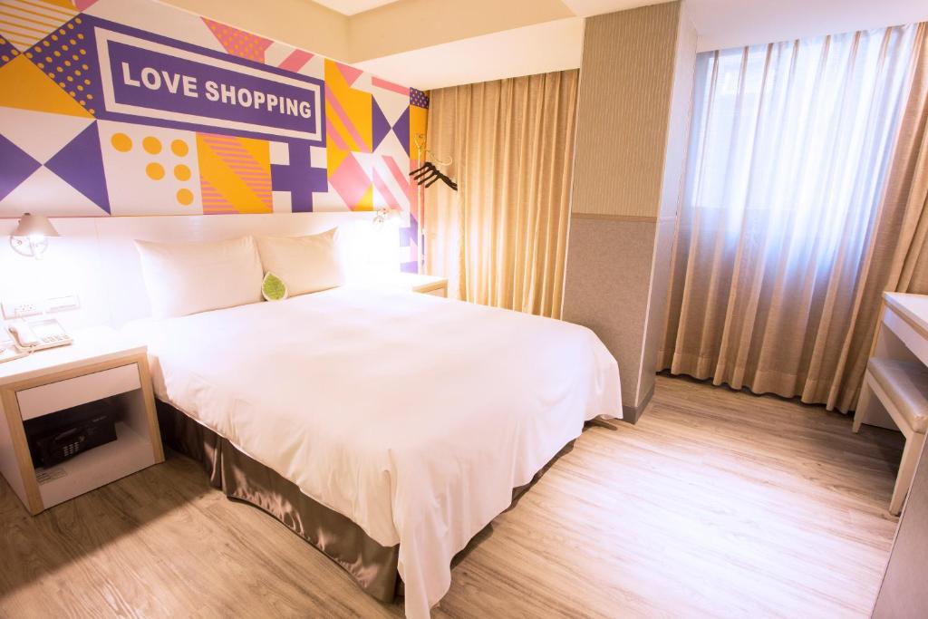 um quarto de hotel com uma cama e uma placa que lê compras de amor em Ximen Citizen Hotel em Taipei