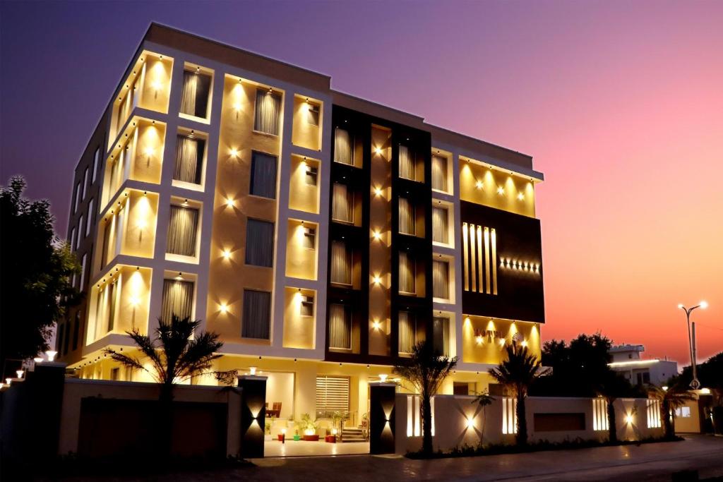 a large building with lights on it at night at Hotel Aarna in Jaipur