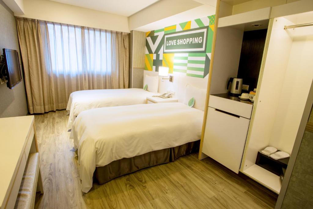 Postel nebo postele na pokoji v ubytování Ximen Citizen Hotel