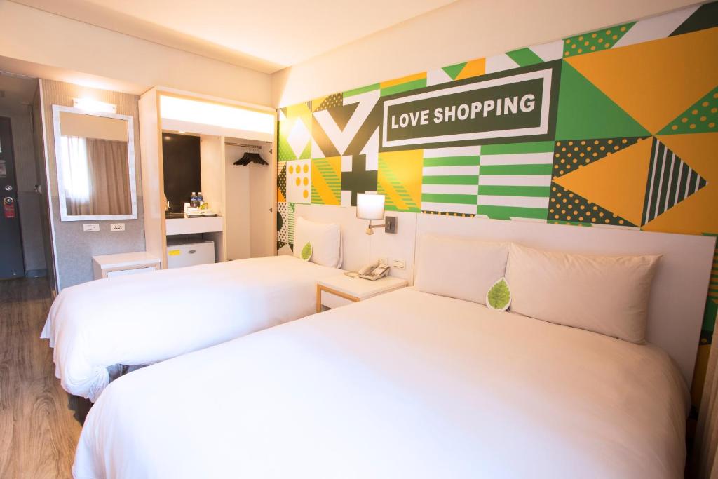 Postel nebo postele na pokoji v ubytování Ximen Citizen Hotel