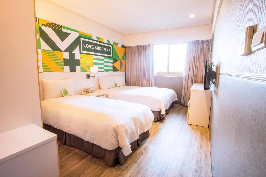 Postel nebo postele na pokoji v ubytování Ximen Citizen Hotel