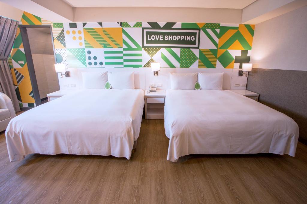 Postel nebo postele na pokoji v ubytování Ximen Citizen Hotel