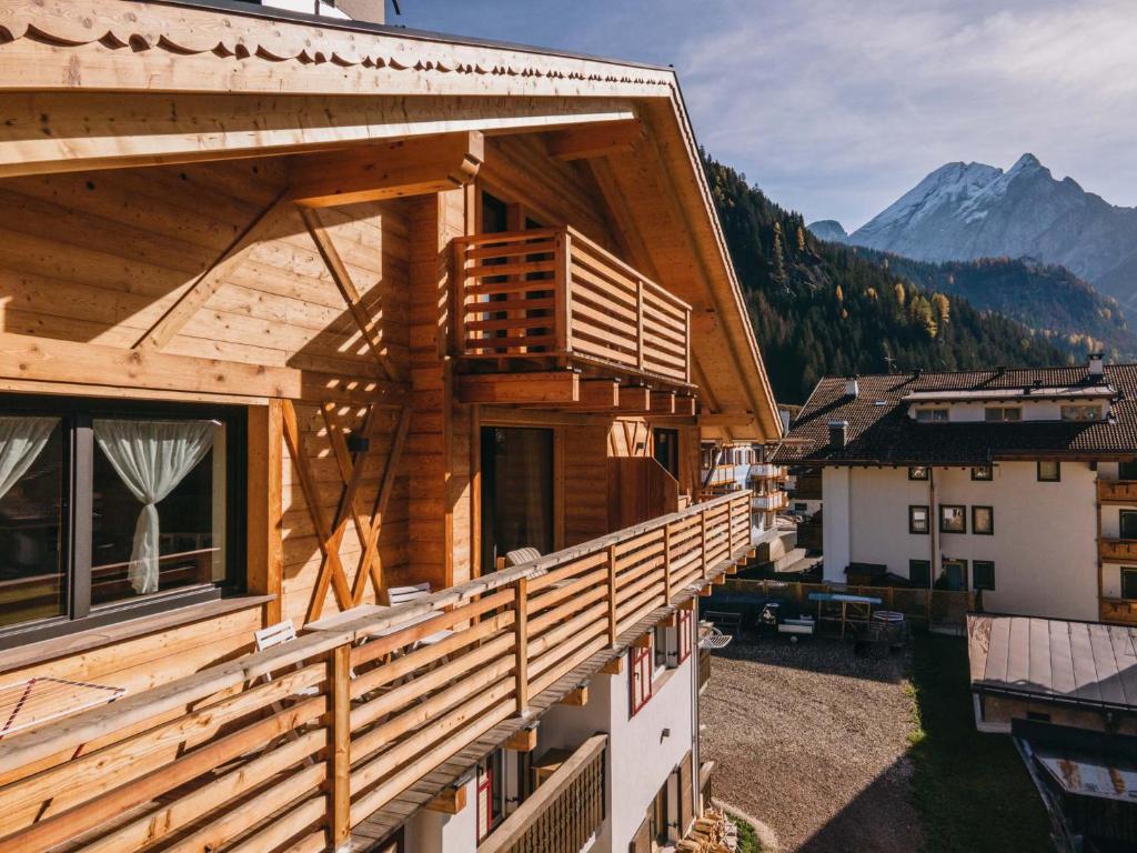 an image of a house with a balcony at Appartamenti Cèsa Sorèie by AMA Val di Fassa in Canazei