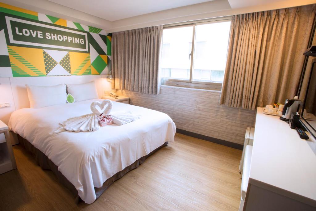 Postel nebo postele na pokoji v ubytování Ximen Citizen Hotel