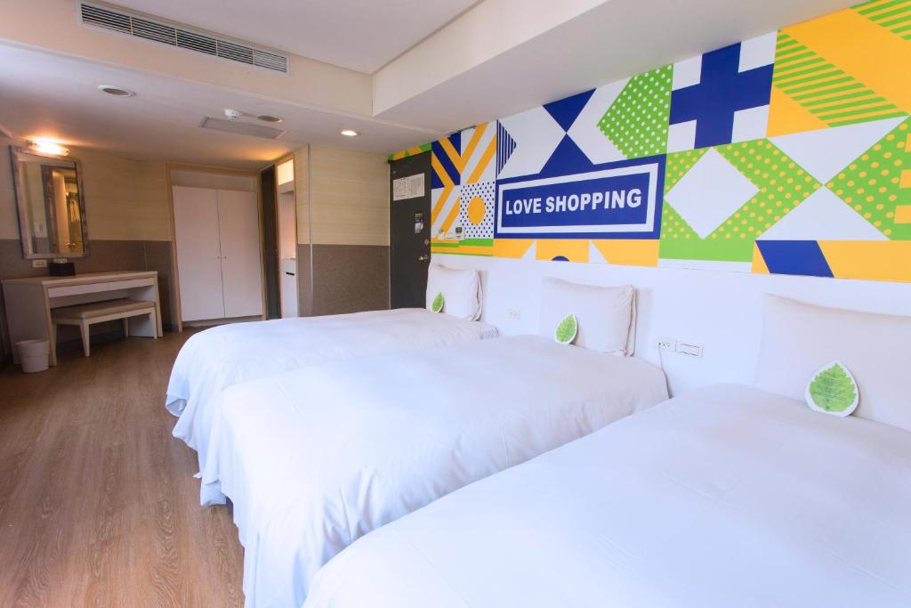 a hotel room with two beds and a not smoking sign at Ximen Citizen Hotel in Taipei
