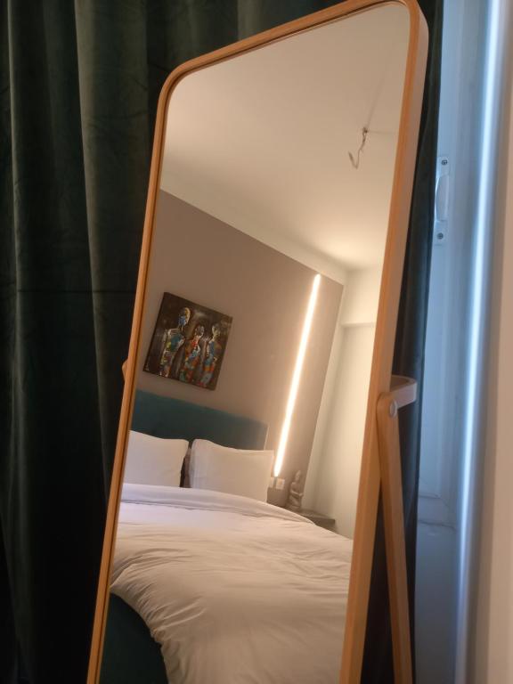 a mirror over a bed in a room at Apollonas - 1BR Lux Apartment - Tsimiski Ladadika - Explore Center by foot - Close to Aristotelous square in Thessaloniki