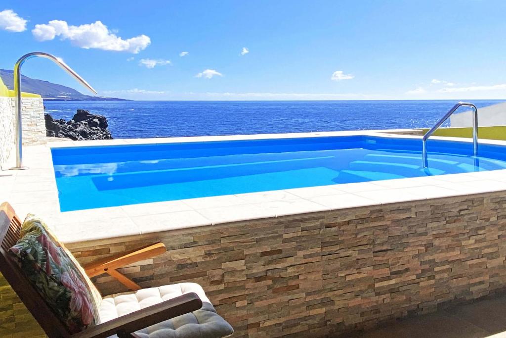 洛斯利亞諾斯德亞里達內的住宿－Casa La Caleta，一座背景海洋的游泳池