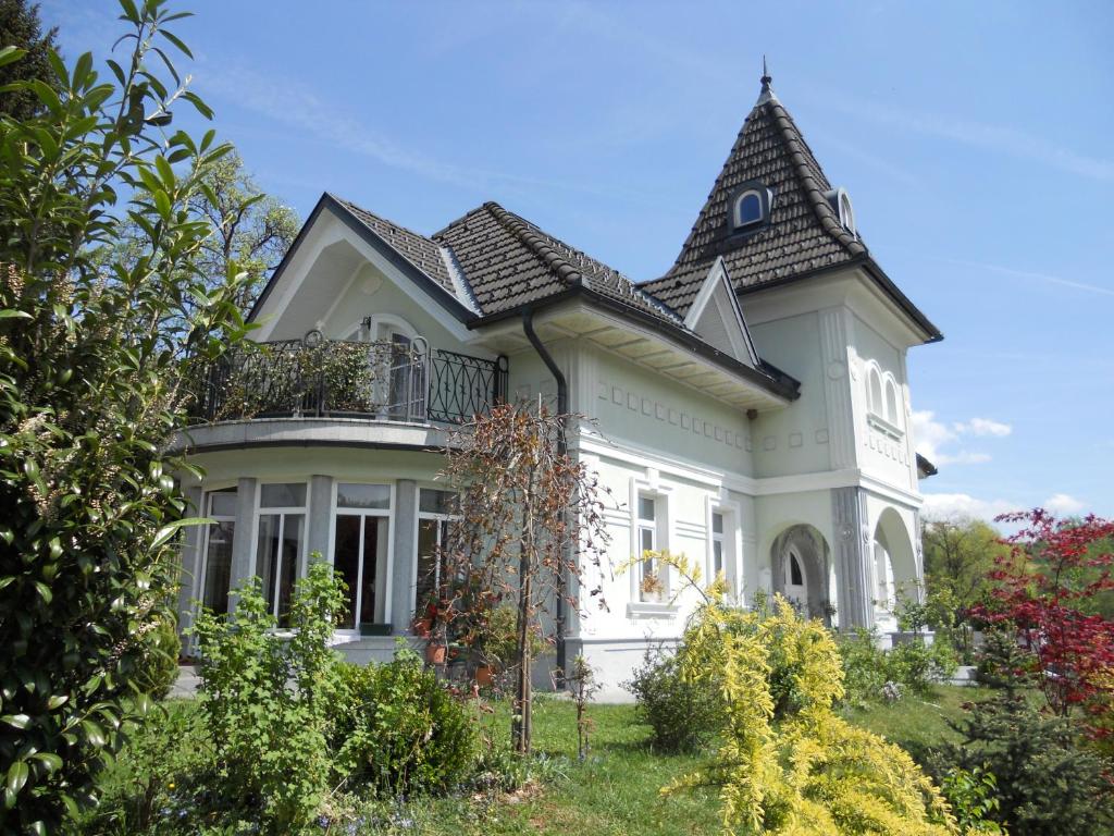 a large white house with a roof at Vila Mirjam in Radovljica