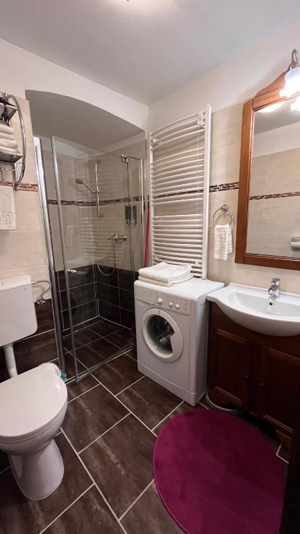 a bathroom with a washing machine and a sink at Mirage Apartments Váci Street in Budapest