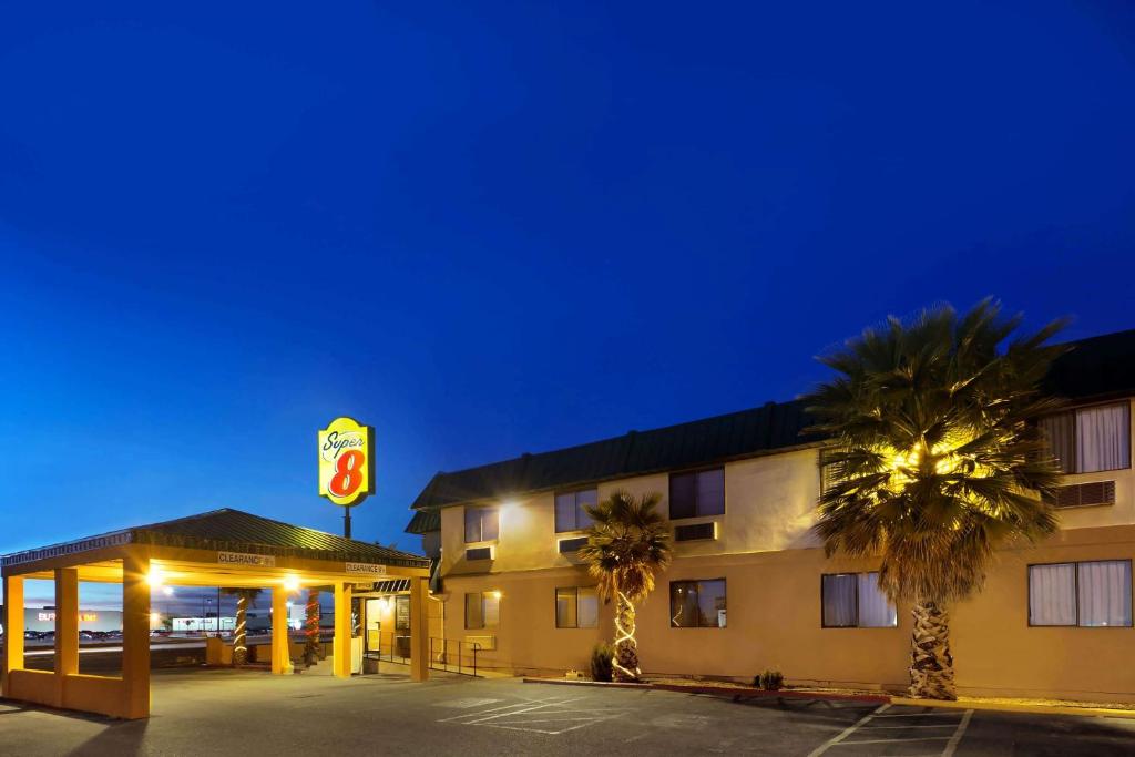 a hotel with a sign in front of a parking lot at Super 8 by Wyndham Alamogordo in Alamogordo