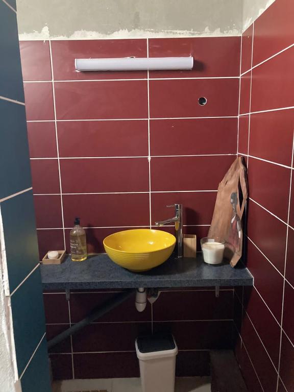 a bathroom with a yellow bowl sink on a counter at Yeux D&#39;azur in Le Souffleur