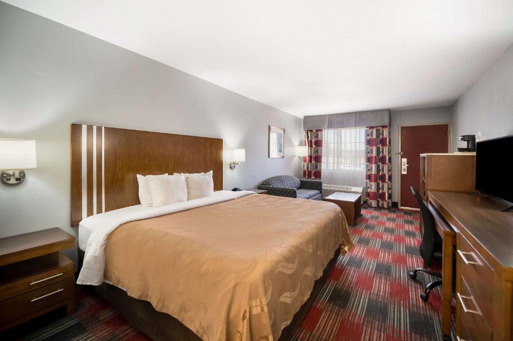 ナッキトッシュにあるQuality Inn near Parc Natchitochesのベッドとテレビが備わるホテルルームです。