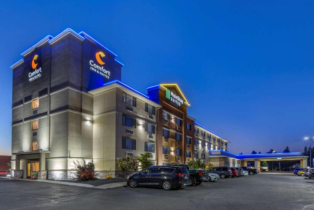 a hotel building with cars parked in a parking lot at Comfort Inn & Suites Coeur d'Alene in Coeur d'Alene