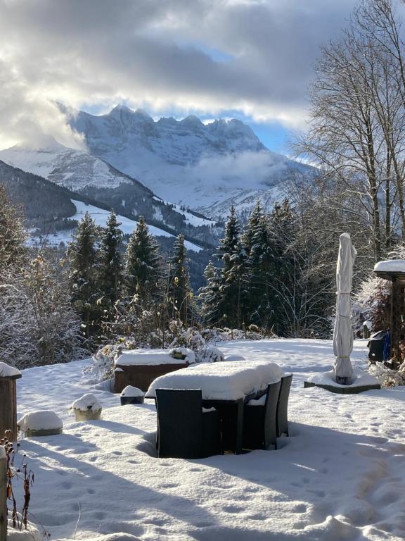 a snow covered patio with a view of a mountain at Chalet Ingas in Troistorrents