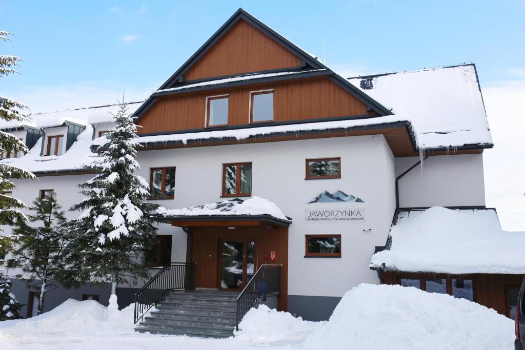 a house in the snow with snow covered steps at Jaworzynka 89 in Jaworzynka