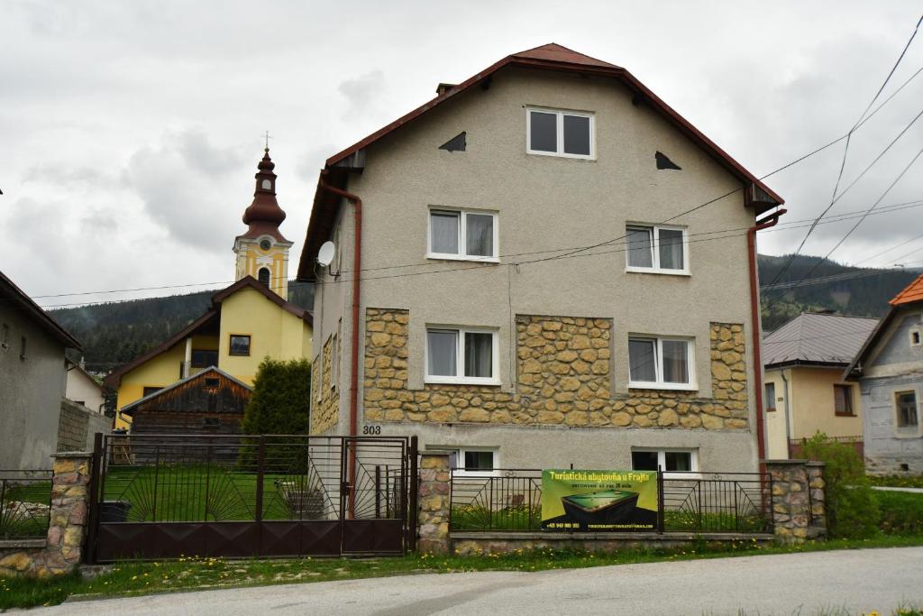 a large house with a fence in front of it at Turistická ubytovňa u Frajta in Telgárt