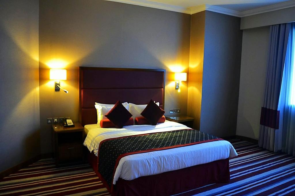 Postel nebo postele na pokoji v ubytování Wonder Palace Hotel Qatar