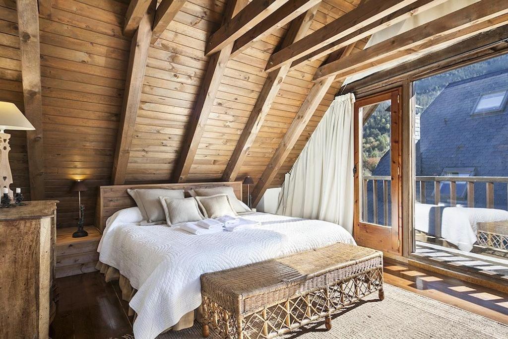 a bedroom with a bed and a large window at Luderna - Casa Sendrosa in Gessa