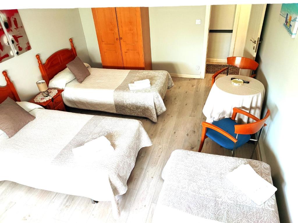 Ein Bett oder Betten in einem Zimmer der Unterkunft PENSIÓN PESQUERO