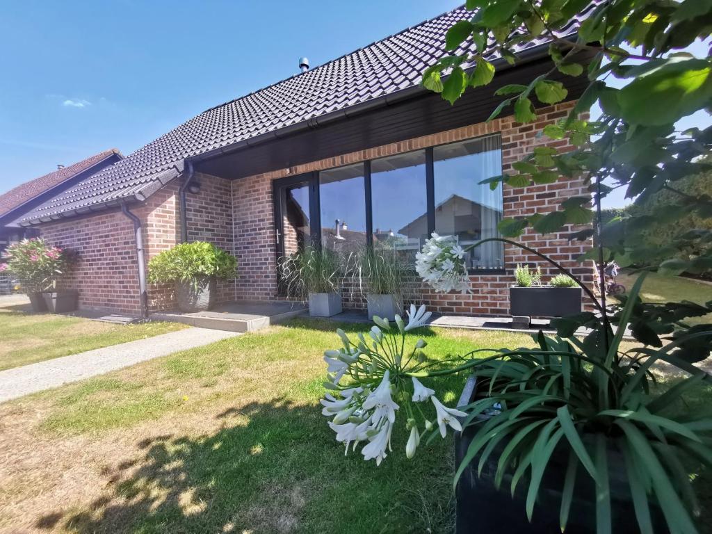a brick house with large windows and plants at Seaside in Middelkerke