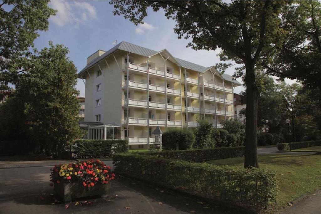 a large white building with flowers in front of it at Appartement Haus Salzburg in Bad Füssing