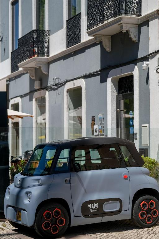 a small car parked in front of a building at RM The Experience - Small Portuguese Hotels in Setúbal