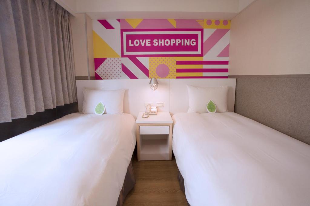 Postel nebo postele na pokoji v ubytování Ximen Citizen Hotel