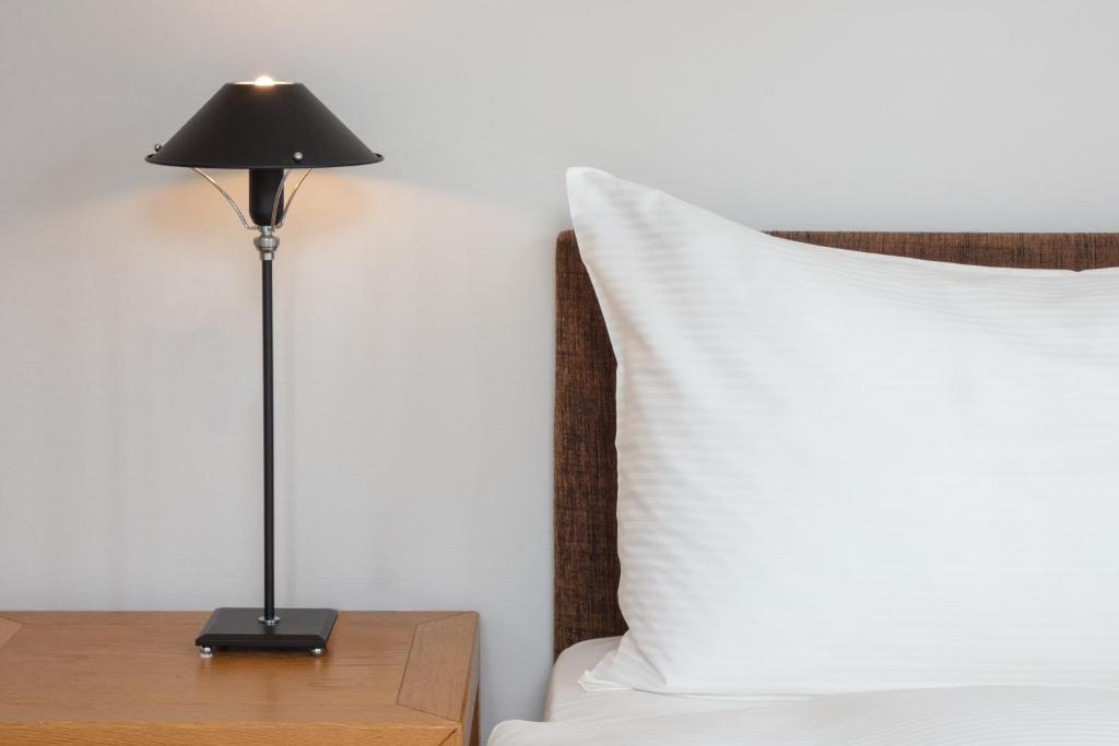 Postel nebo postele na pokoji v ubytování Hotel Baslertor