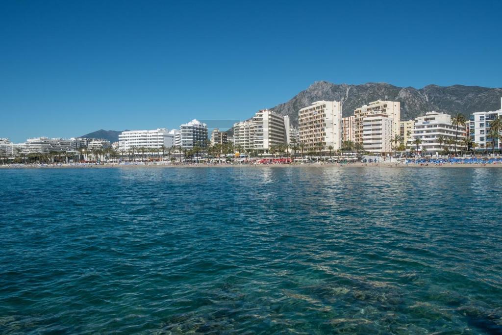 a view of a city from the water at Front sea view apartment on Marbella's beach promenade in Marbella