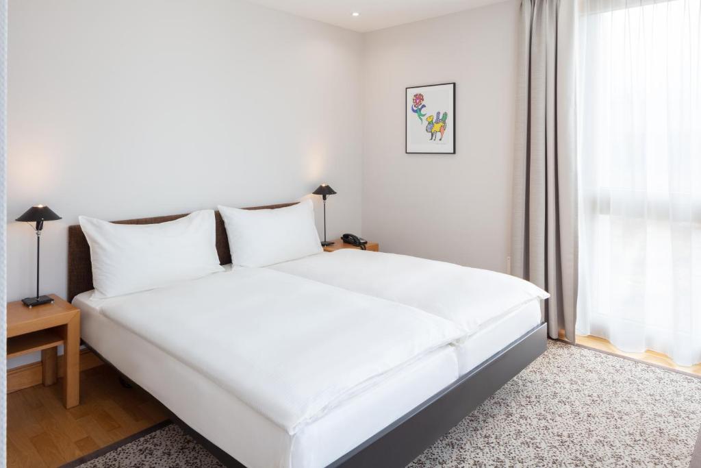 Postel nebo postele na pokoji v ubytování Hotel Baslertor