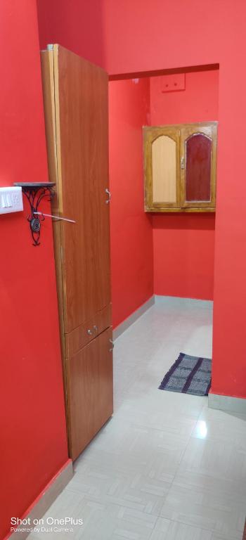 a red room with a door and a red wall at Sajeev Home Stay in Cherai Beach