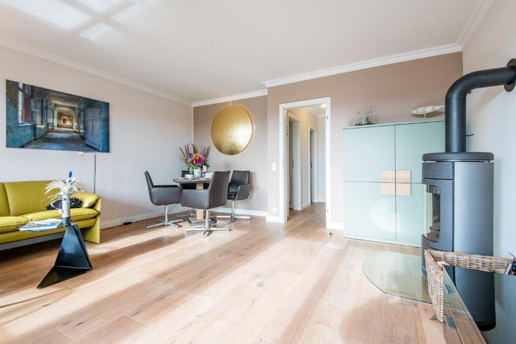 sala de estar con chimenea y sofá amarillo en Haus Sönshörn Whg 07, en Munkmarsch