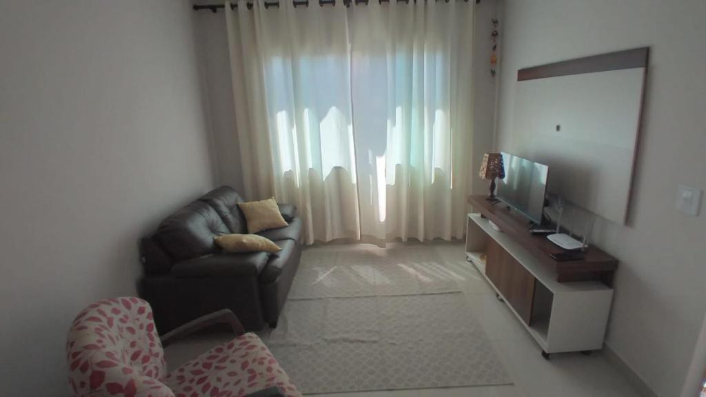 Μια τηλεόραση ή/και κέντρο ψυχαγωγίας στο Casa aconchegante com piscina e bem localizada