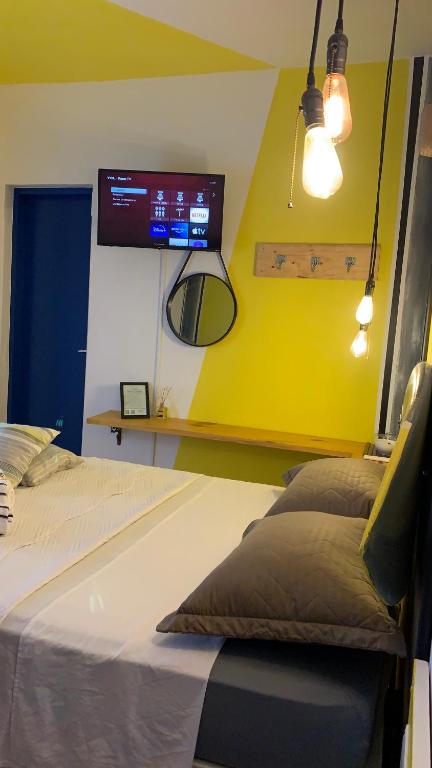 a hospital room with a bed and a tv at Casa Sete Mares in Guarujá