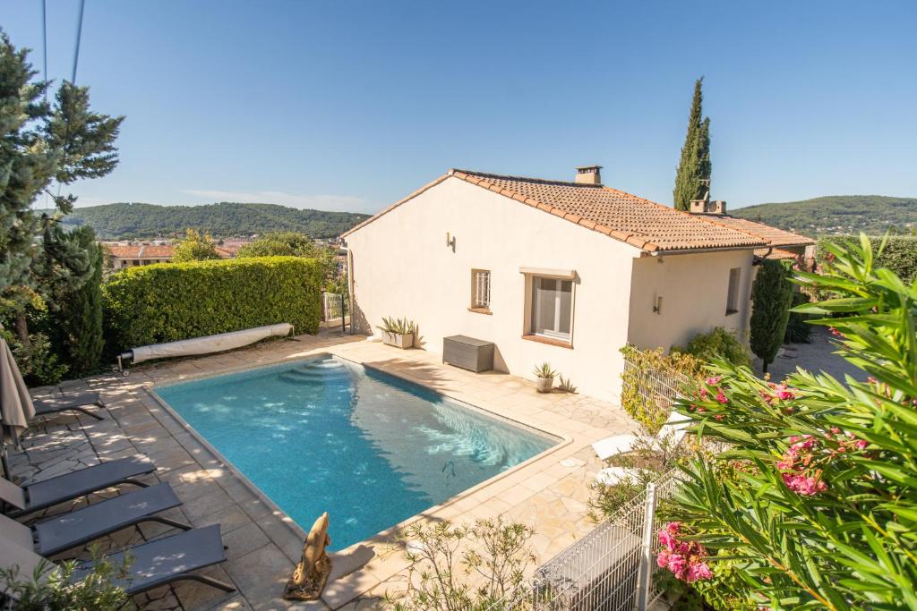 a swimming pool in the backyard of a house at Villa Cécile in Draguignan