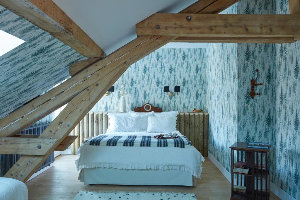 a bedroom with a bed in a attic at Grand Hotel Soleil d'Or in Megève